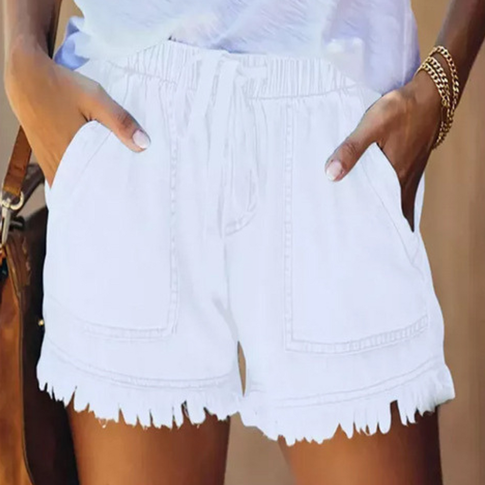 White denim shorts with drawstring waist, two front pockets, and frayed hem.