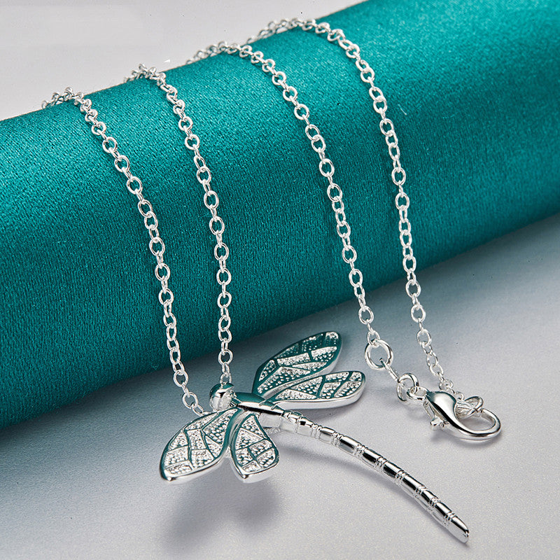Silver-tone dragonfly necklace with feather-quill charm, multiple linked chains