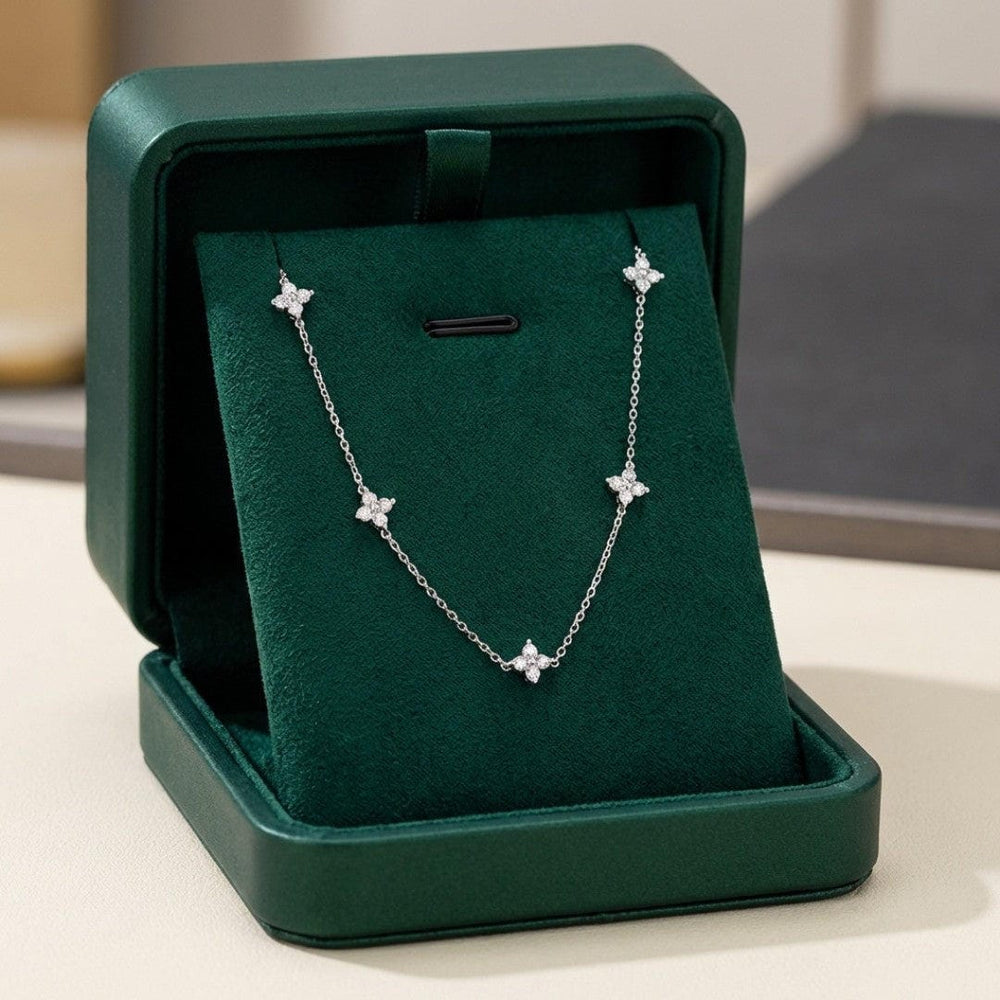 Silver-tone flower zirconia necklace on a jewelry display box