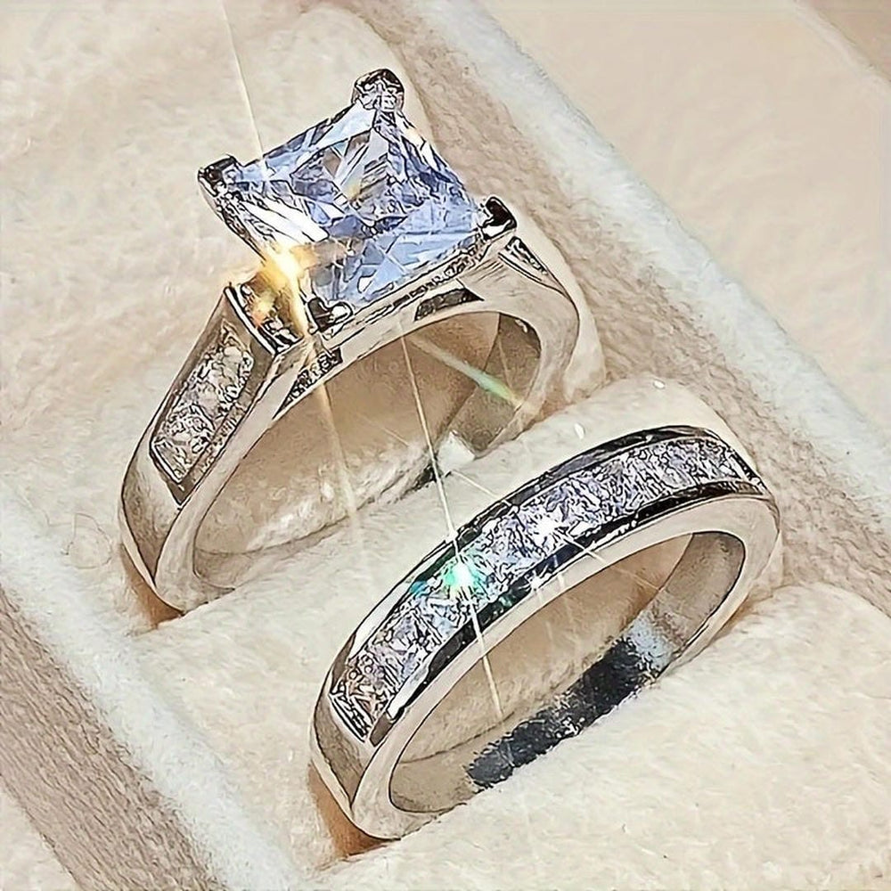 Promise ring set with square center solitaire and pave accents on two silver-tone bands