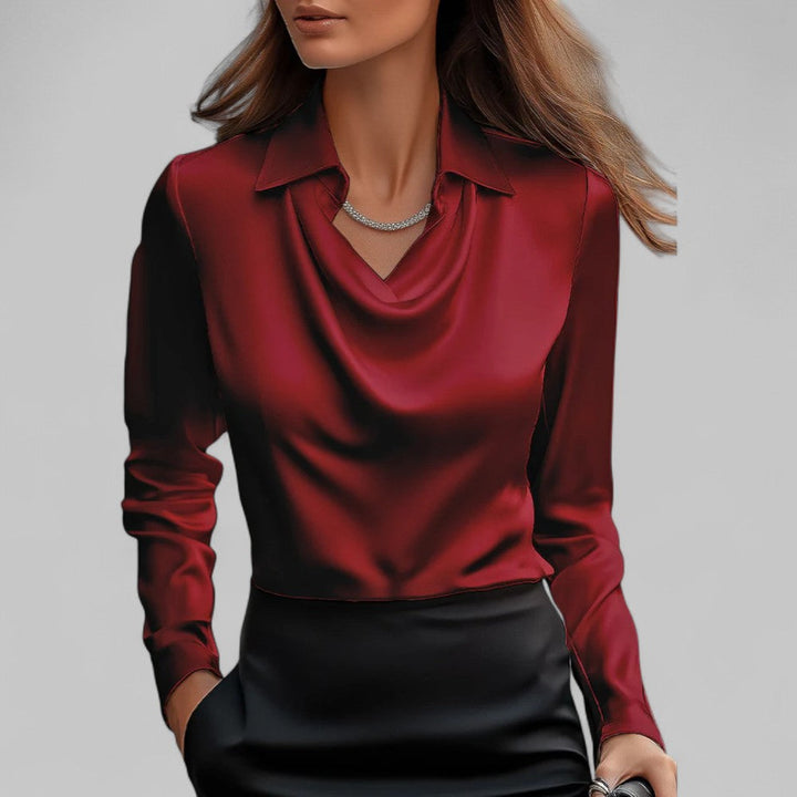 Red satin draped cowl-neck blouse with long sleeves and pointed collar.