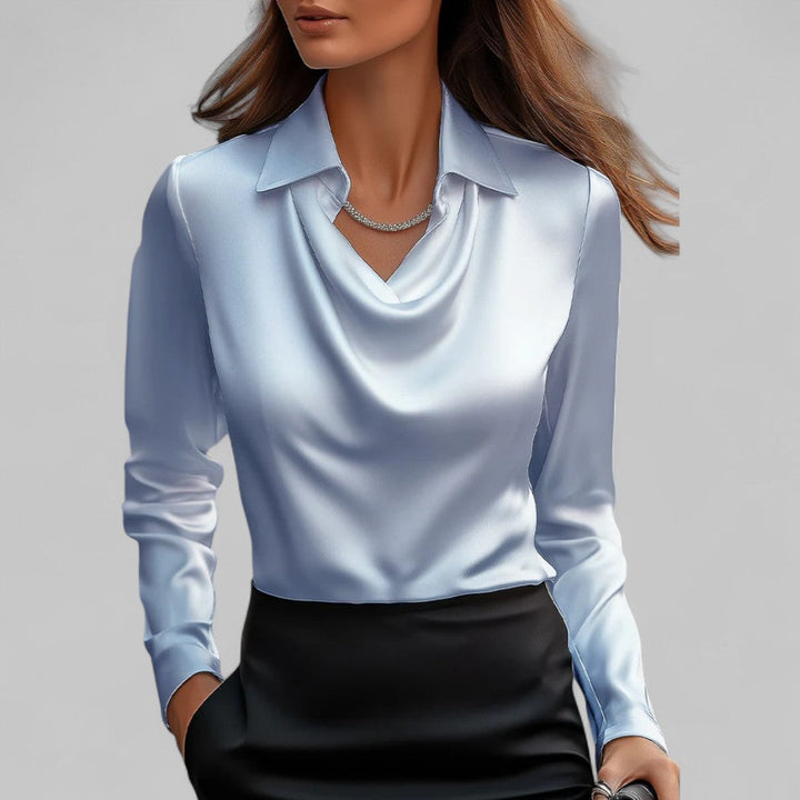 Light blue satin draped cowl-neck blouse with long sleeves and pointed collar.