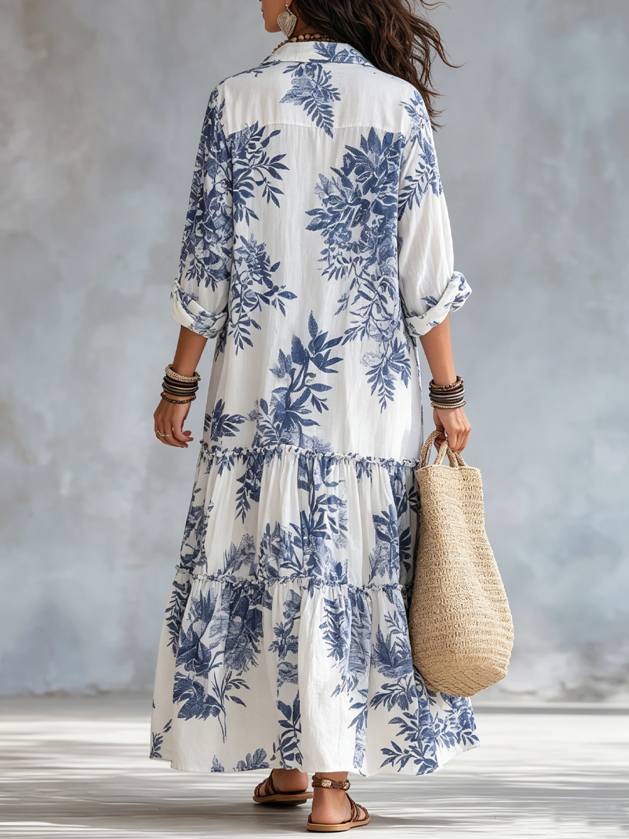 Back view of blue-and-white floral button-down tiered maxi dress with puff sleeves