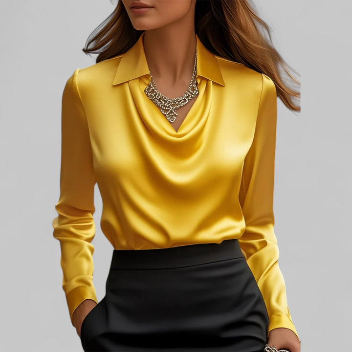 Yellow satin draped cowl-neck blouse with long sleeves and pointed collar.