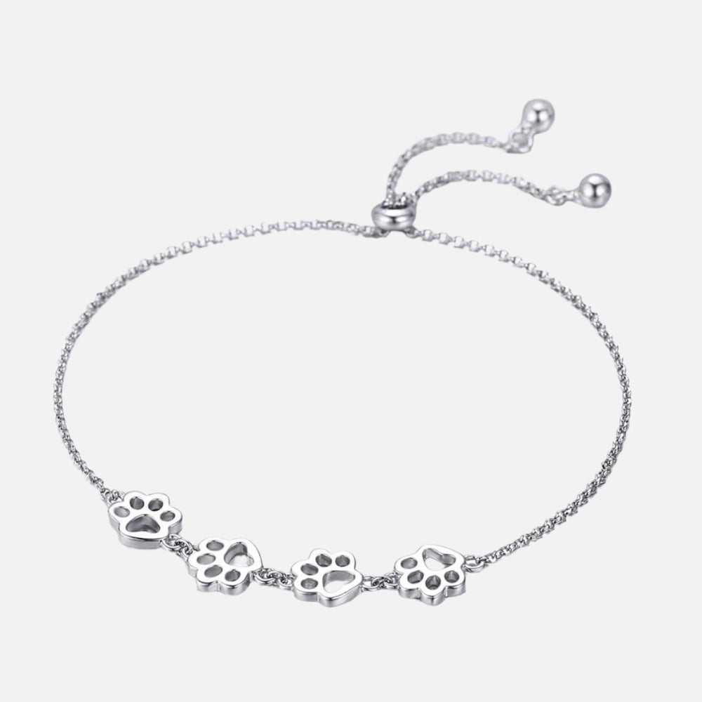 Silver paw print charm bracelet, five paw charms along a fine adjustable chain
