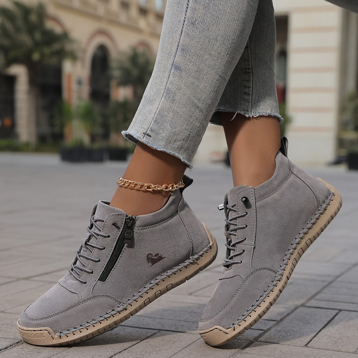 Grey lace-up comfort shoes with side zipper, textured sole, and gold ankle chain
