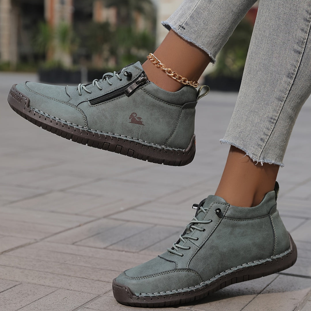 Muted green lace-up comfort shoes with side zipper, contrast stitching, and ankle chain