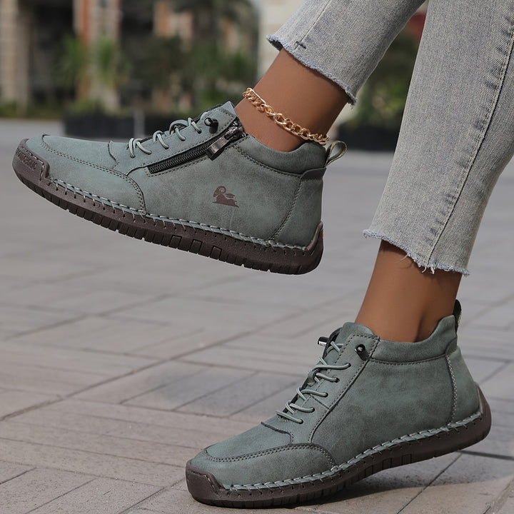 Muted green lace-up comfort shoes with side zipper, contrast stitching, and ankle chain
