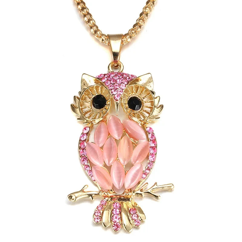 Gold owl pendant necklace with pink crystal eyes and pink leaf-like body