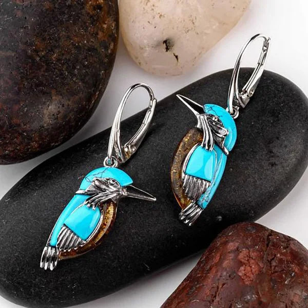 Blue enamel hummingbird charm hoop earrings with silver-toned bird detail