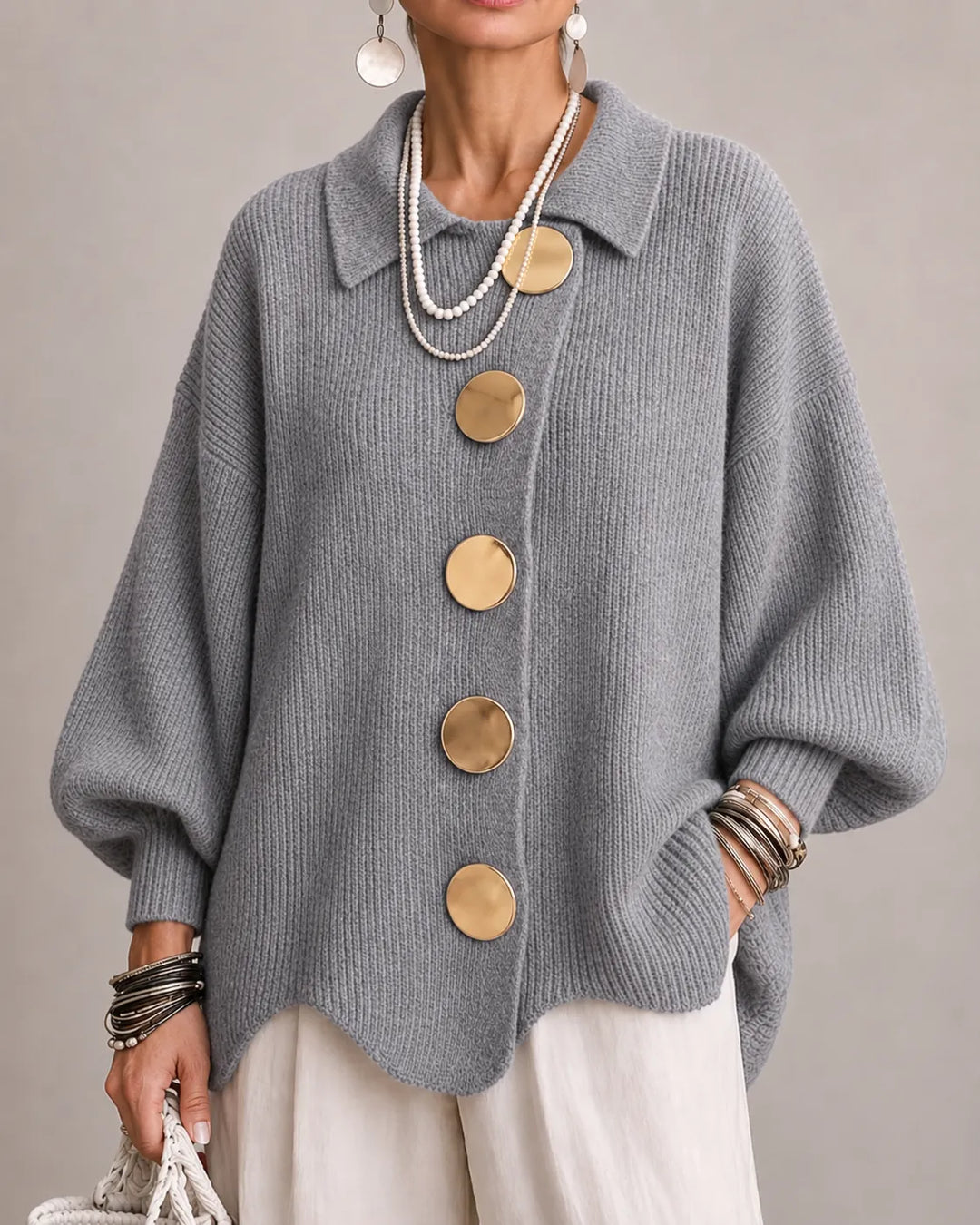 Gray oversized knit sweater with collared neckline and gold button front