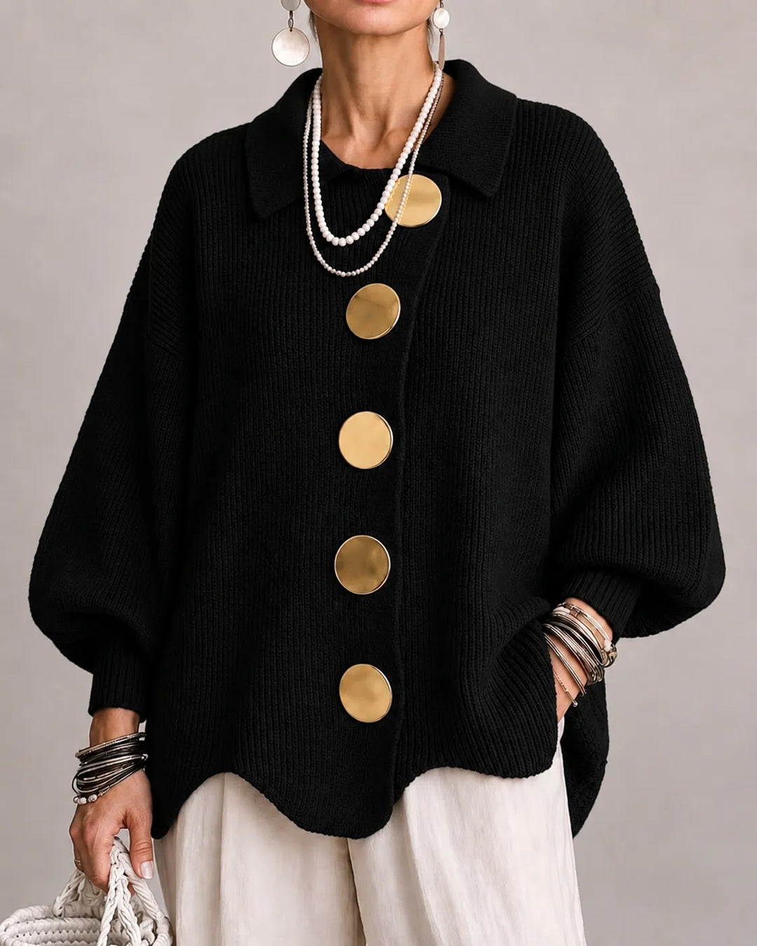 Black oversized knit sweater with collared neckline and gold button front