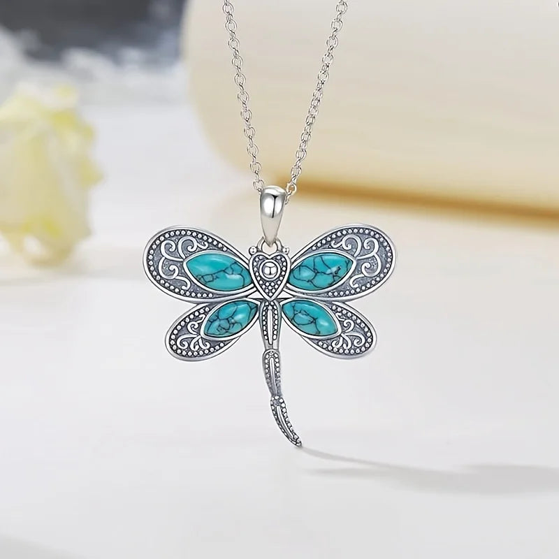 Silver dragonfly pendant necklace with blue oval wing inlays on a silver chain