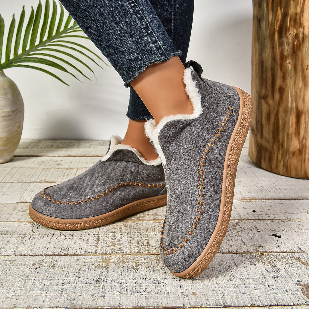 Grey ankle boots with faux-fur lining, stitched moccasin trim, and textured sole
