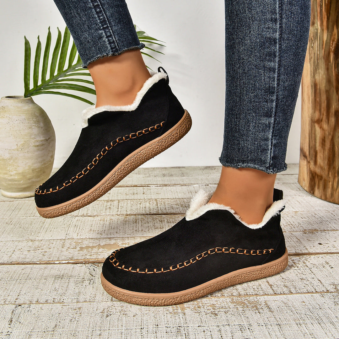 Black ankle boots with faux-fur collar lining, stitched moccasin band, and rubber sole