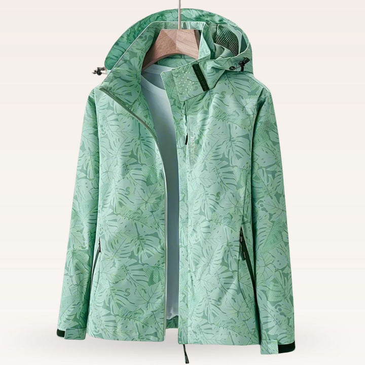 Women’s waterproof hooded jacket in green with leaf print, full zip and side pockets