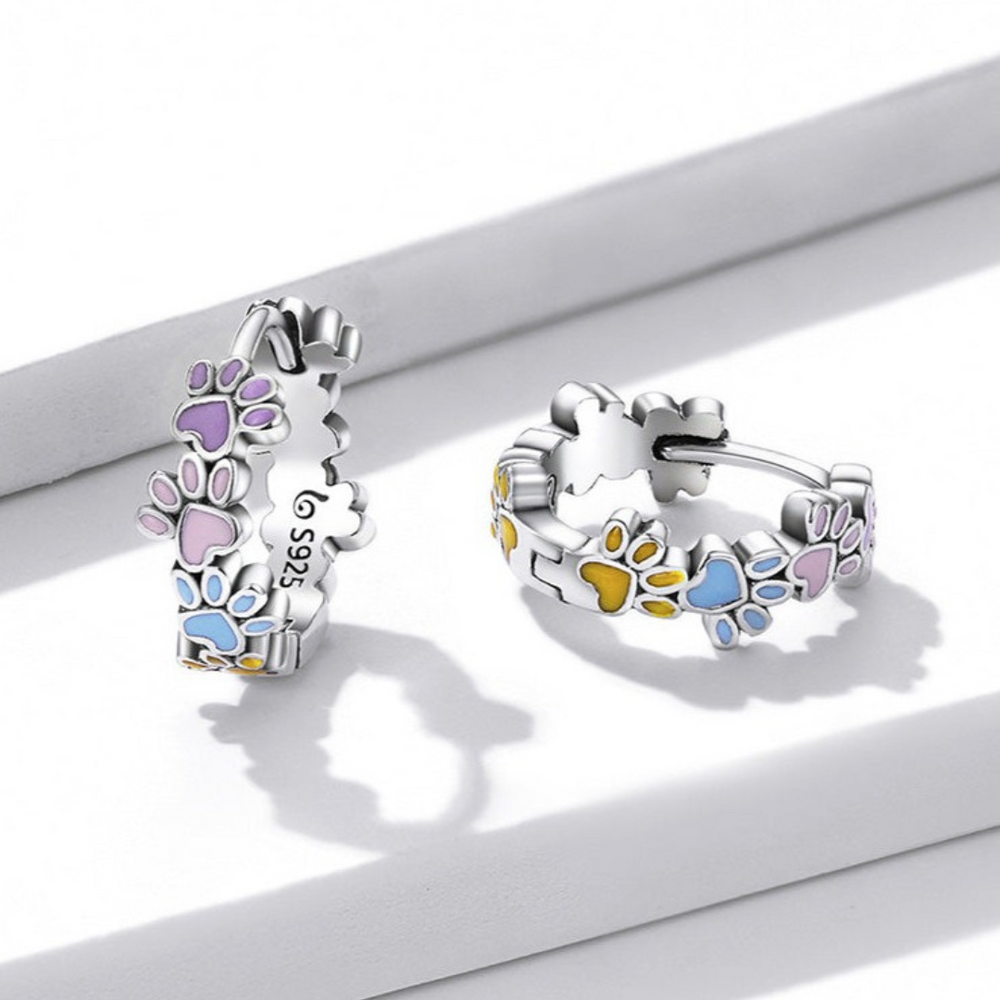 Sterling silver paw print hoop earrings with purple and blue enamel accents
