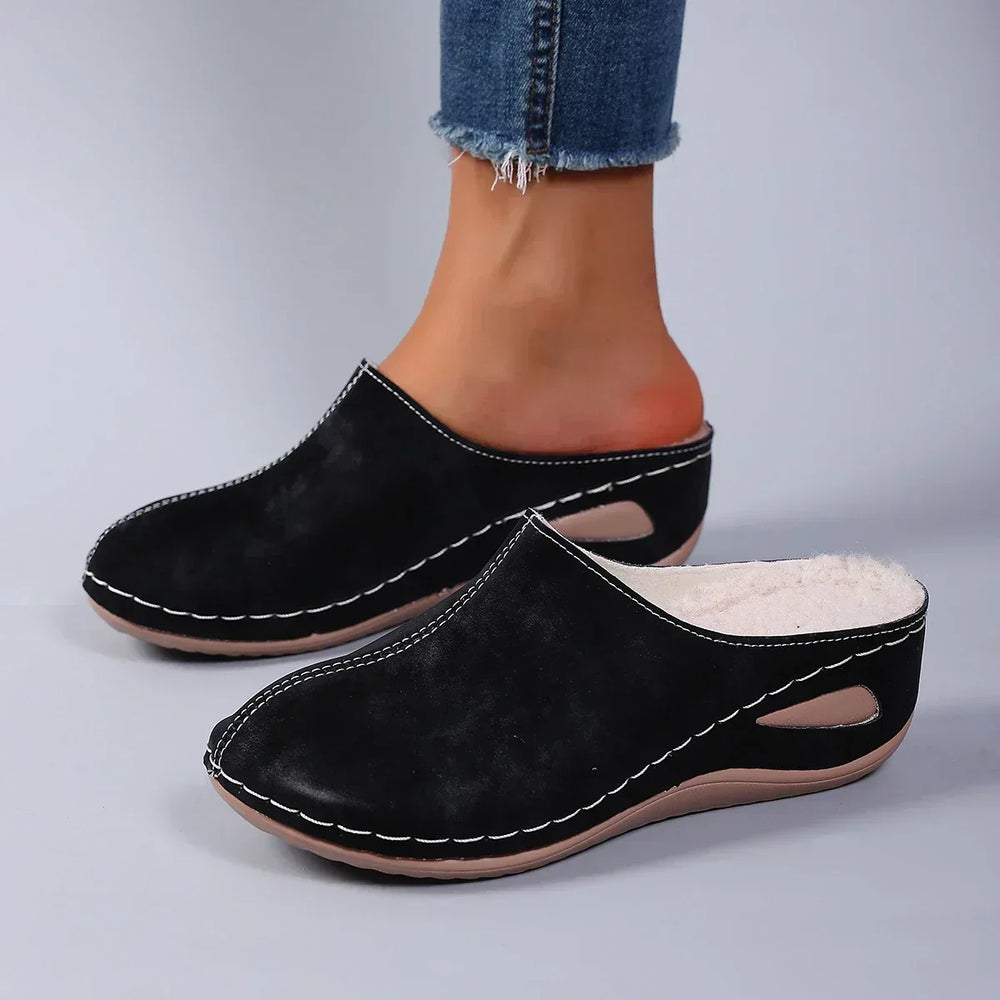 Black orthopaedic slip-on slippers with stitched moc toe and faux-fur lining