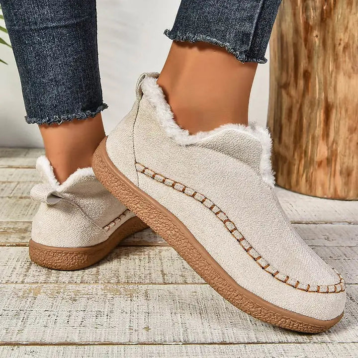Oatmeal ankle boots with sherpa-style lining, moccasin stitch detail, and brown sole