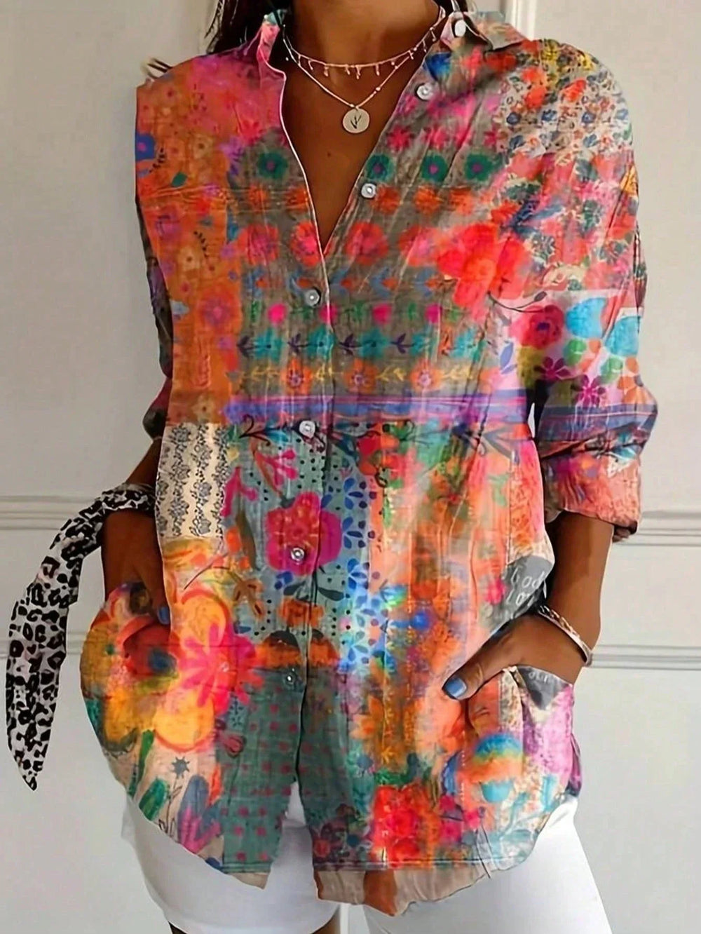 Multicolor collage print blouse with button front, long sleeves, orange pink teal floral motifs
