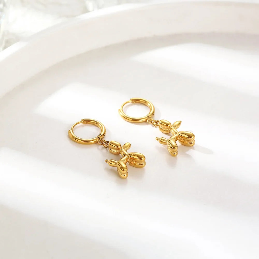 Gold-tone hoop earrings with mini balloon dog charms, small hinged huggies