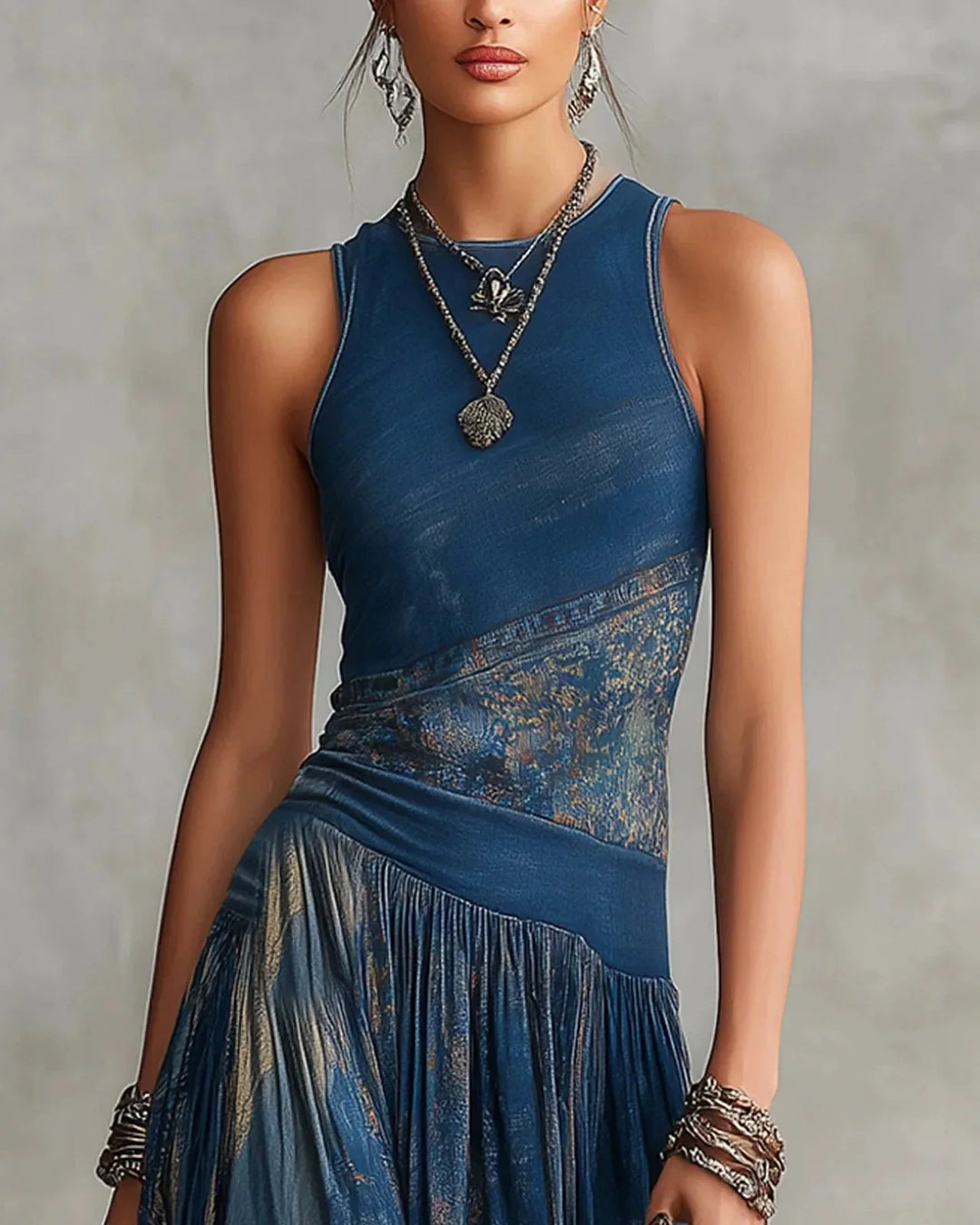 Blue sleeveless boho maxi dress with aztec-style band at waist and gathered tier skirt
