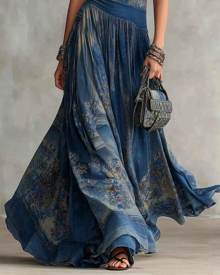 Blue boho maxi dress with flowing tiered skirt and aztec-style print panels at waist