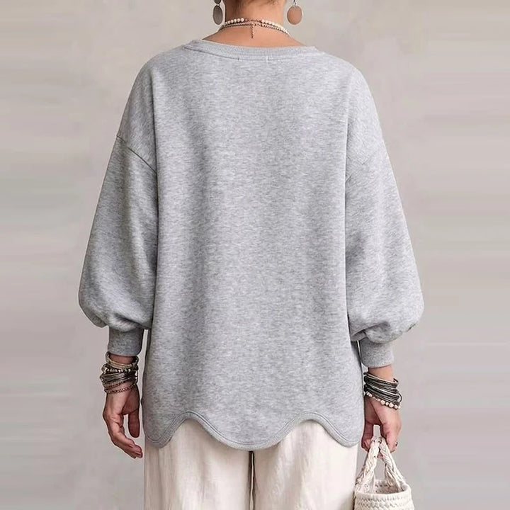 Light grey oversized sweatshirt with wavy hem, back view, loose long sleeves