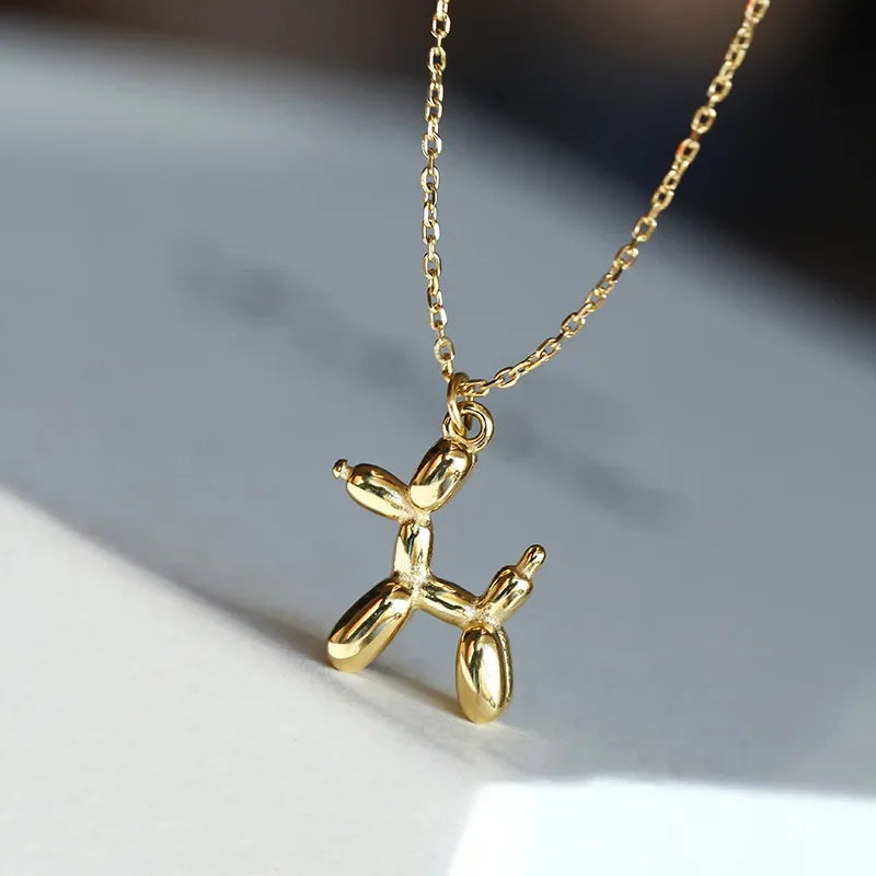 Gold-tone balloon dog pendant necklace with open-link chain and balloon dog charm