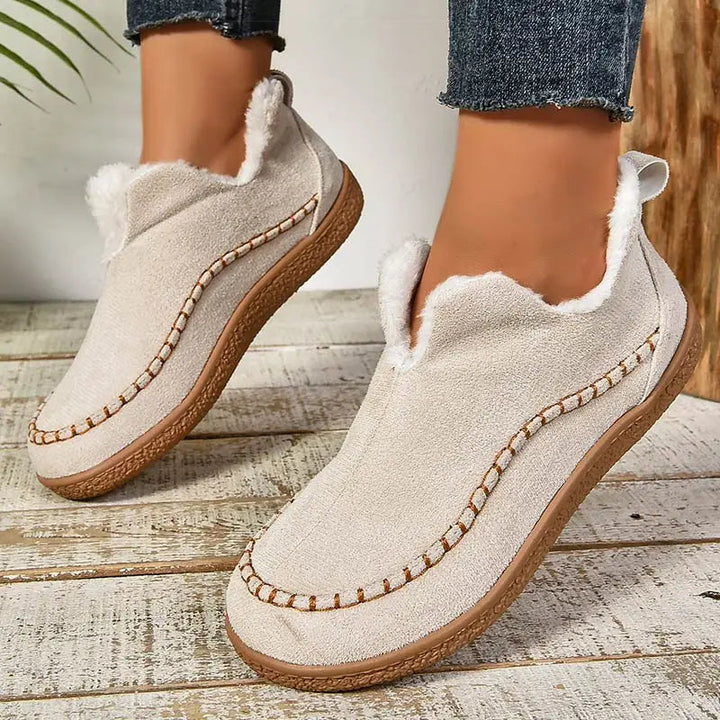 Oatmeal ankle boots with faux-fur lining, moccasin style stitching, and textured sole
