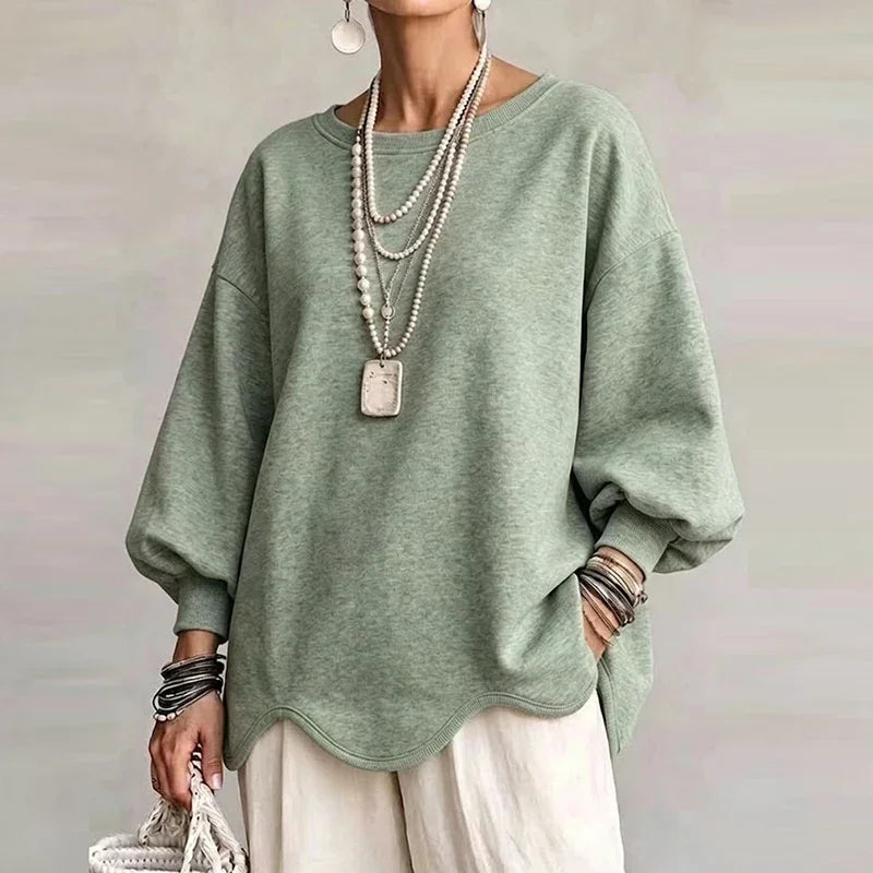 Sage green oversized sweatshirt with wavy hem and relaxed long sleeves