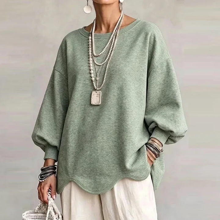 Sage green oversized sweatshirt with wavy hem and relaxed long sleeves