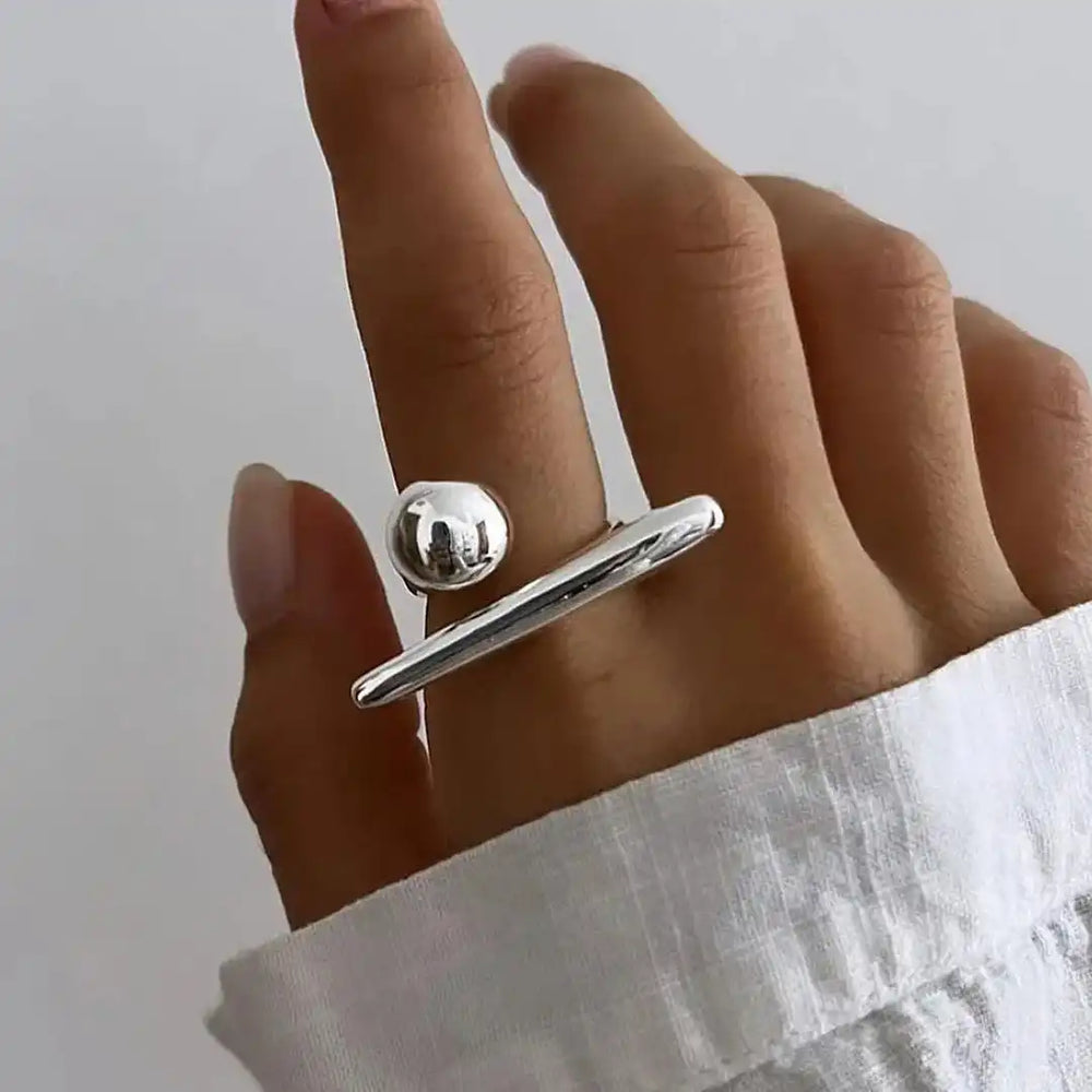 Adjustable white gold star ring with round star charm and slender curved band