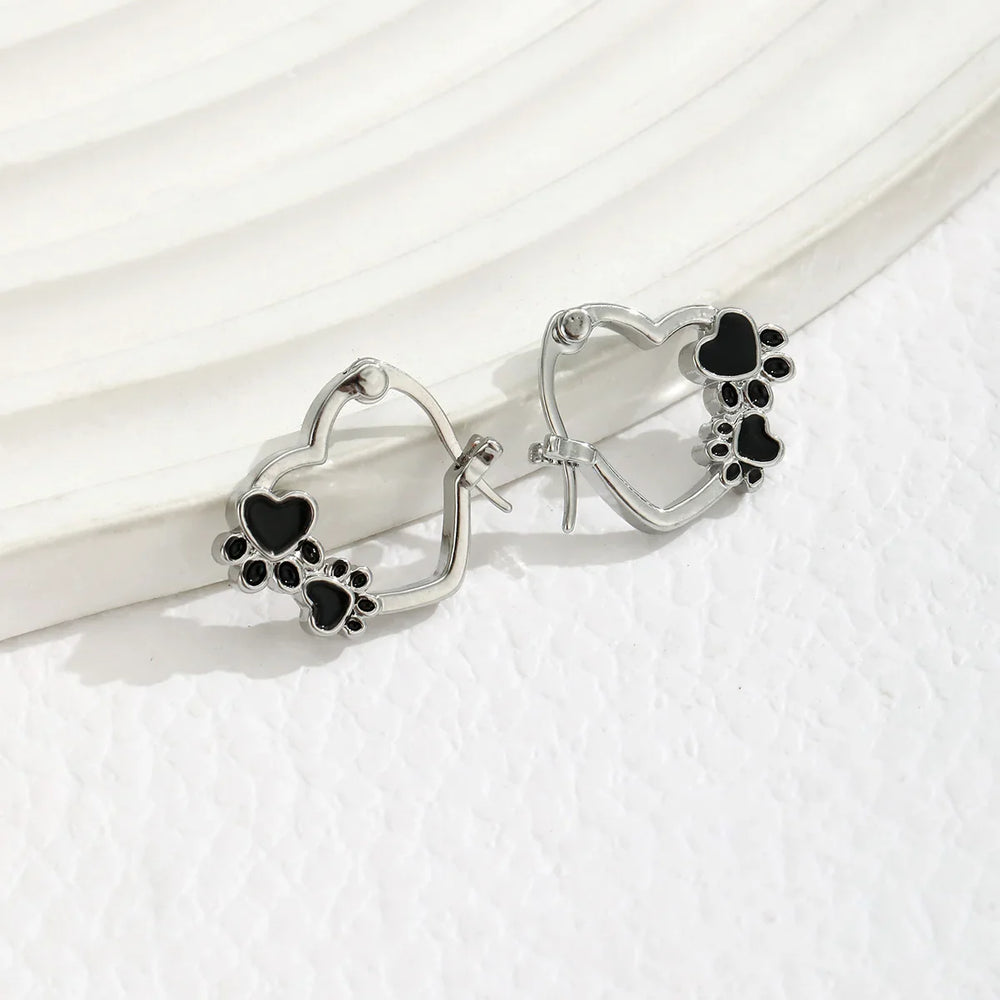 Heart and paw huggie hoop earrings in silver with black enamel, hinged backs