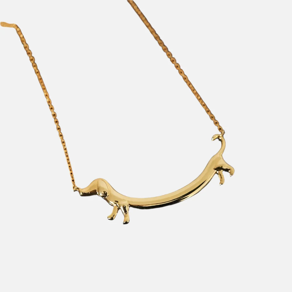 Gold-tone dachshund pendant necklace, curved bar with raised dog figures