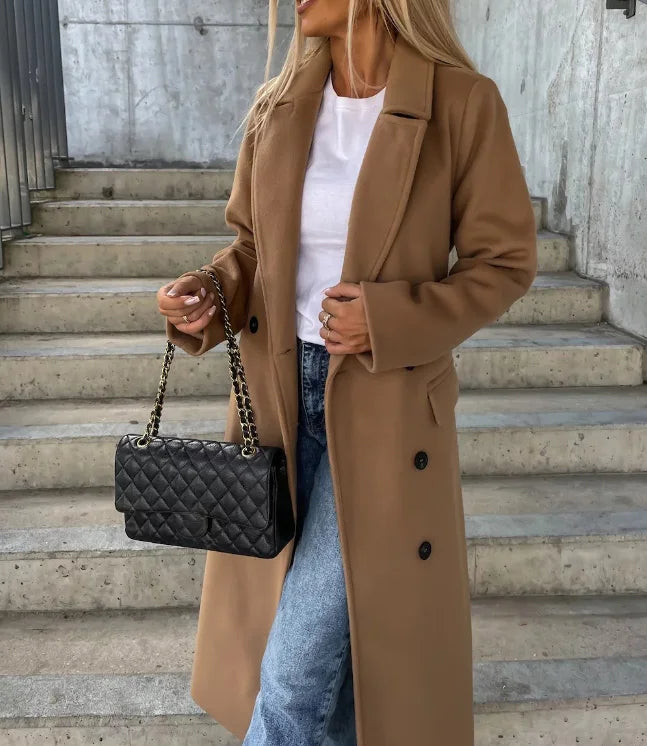 Tan long sleeve trench coat with tie belt and double-breasted button details