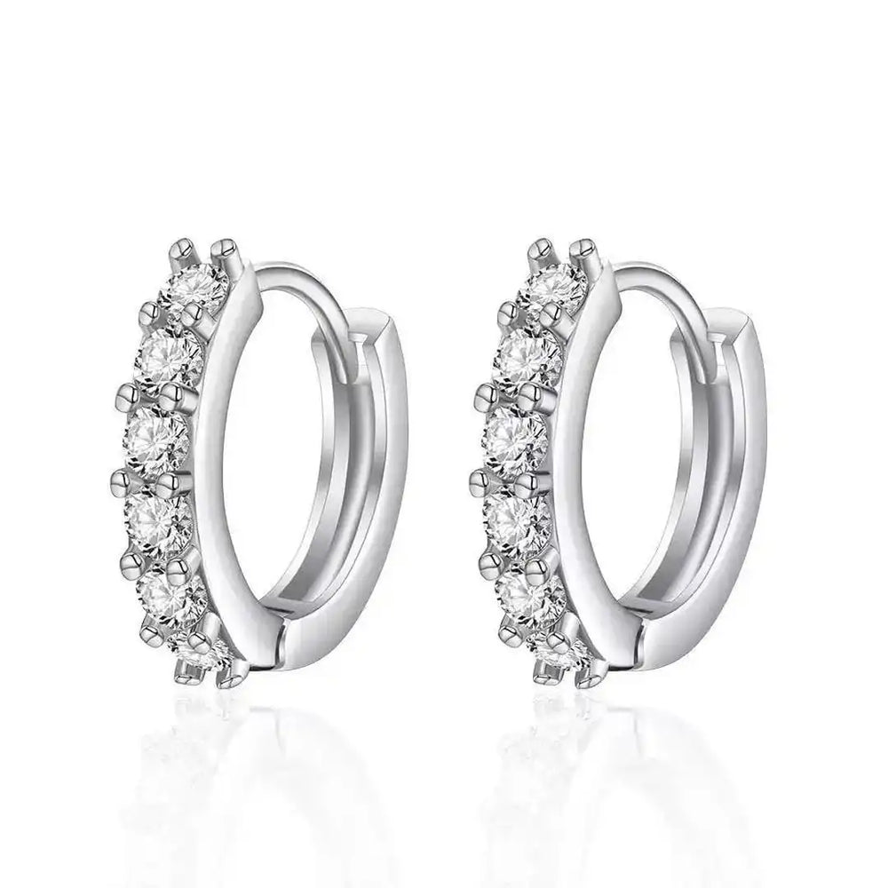White gold mini hoop earrings with multiple round clear stones along the outer edge