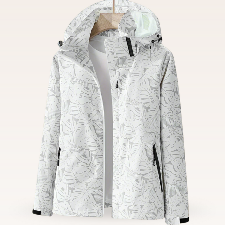 Women’s waterproof hooded jacket in white with leaf print, full zip and side pockets