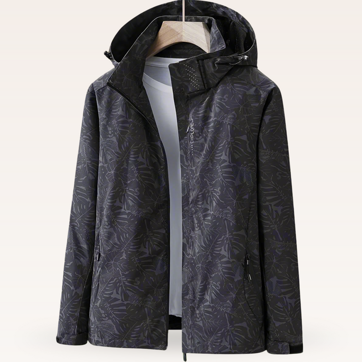 Women’s waterproof hooded jacket in black with leaf print, full zip and side pockets