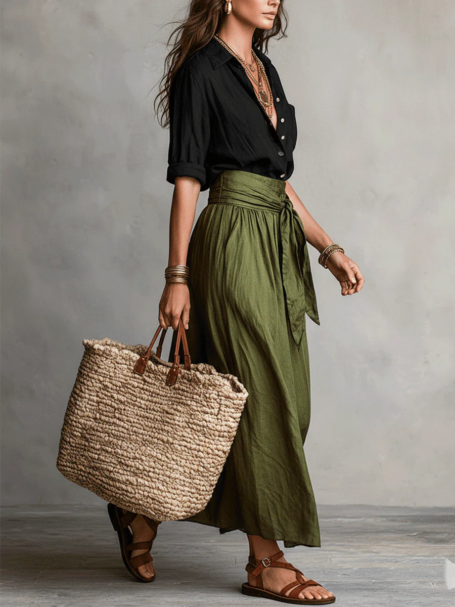 Two-piece set with black blouse and olive-green midi skirt, draped tied waist
