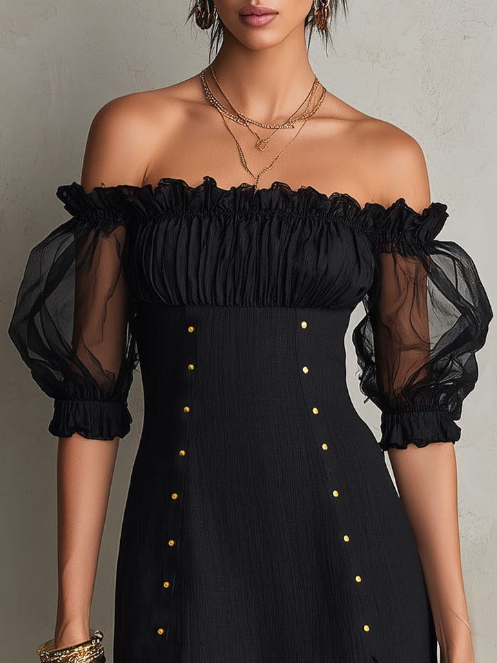 Black mini dress with puff sleeves and studs on the shoulders