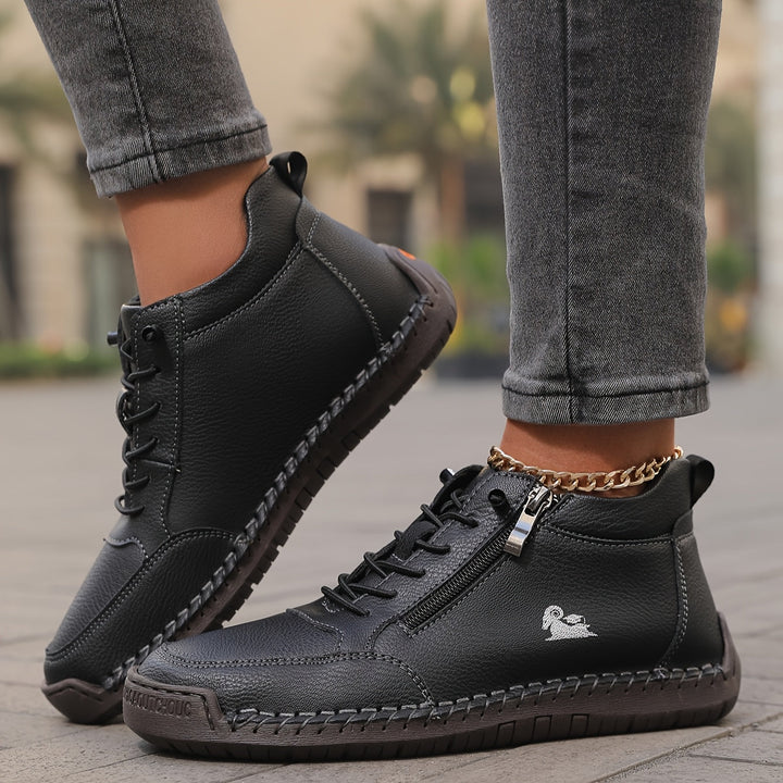 Black lace-up comfort shoes with side zipper, contrast stitching, and gold chain