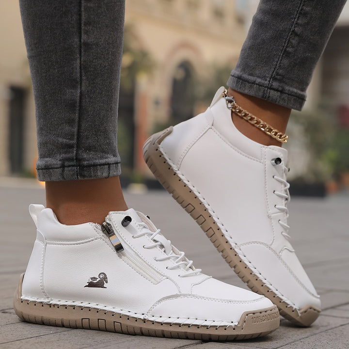 White lace-up comfort shoes with side zipper and gold chain ankle strap
