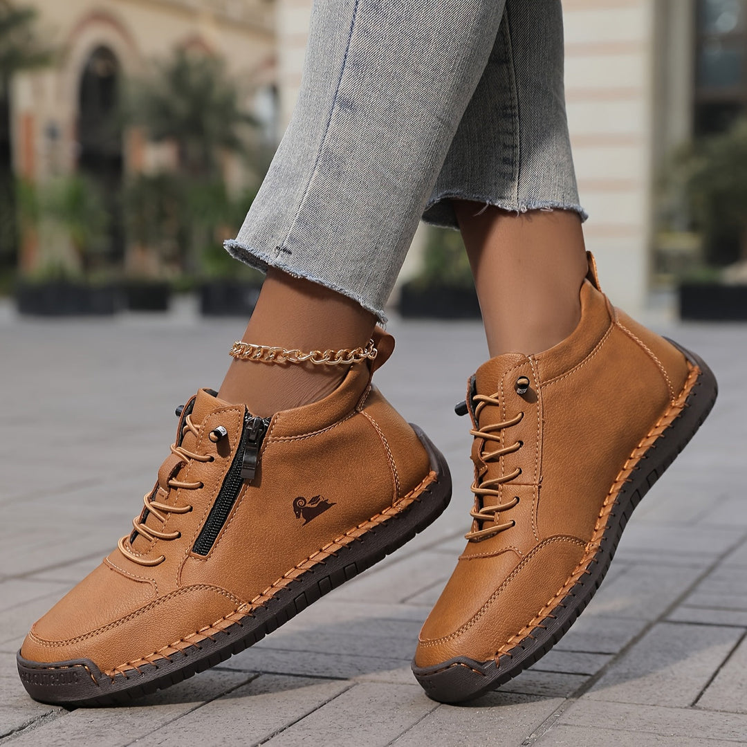 Brown lace-up comfort shoes with side zipper, contrast stitching, and gold chain