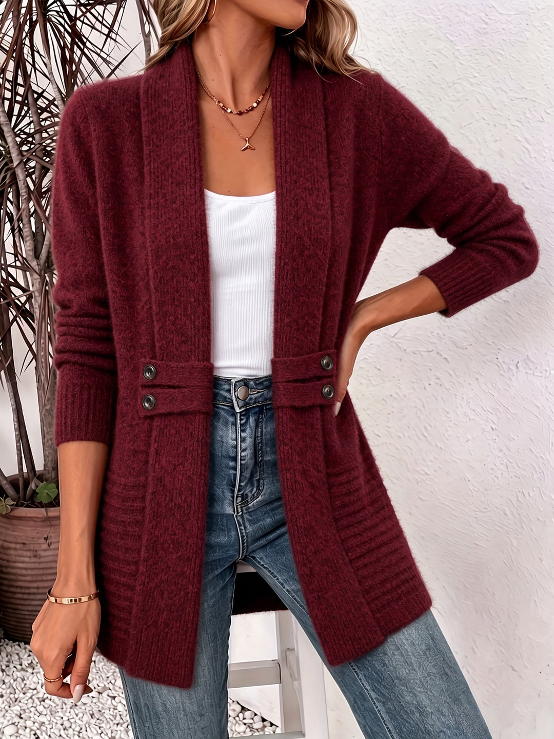 Burgundy knit ladies cardigan, open front with two-button placket and side pockets.