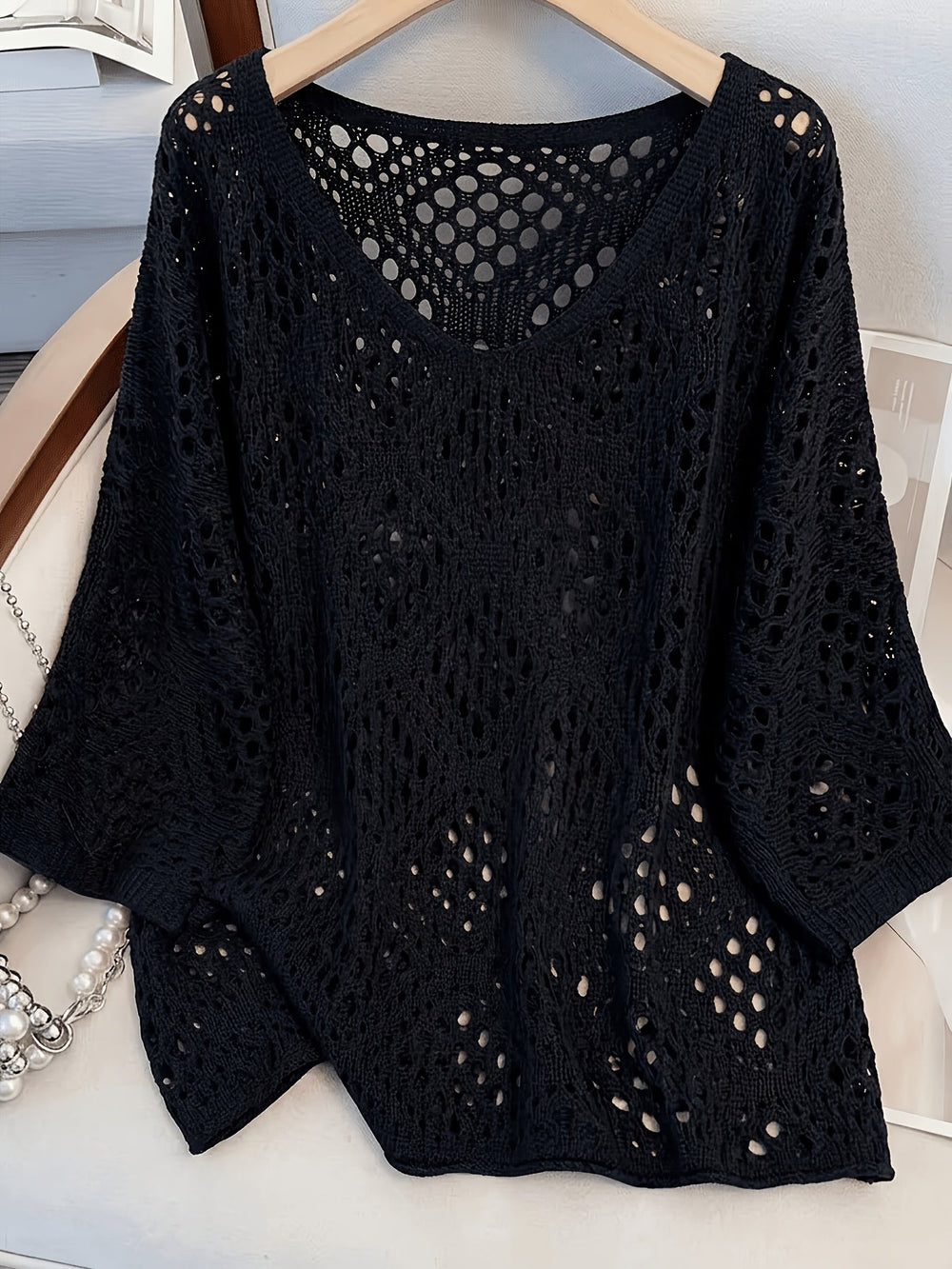 Black open-knit V-neck jumper with batwing sleeves and circular eyelet knit detail