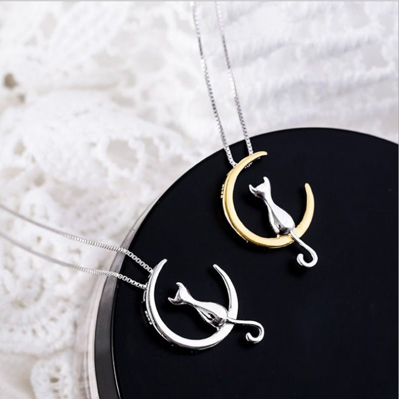 Gold and silver cat crescent pendant necklaces with cat charms on silver chains