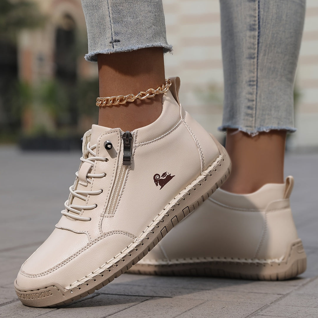 Light beige lace-up comfort shoes with side zipper, stitched sole, and ankle chain