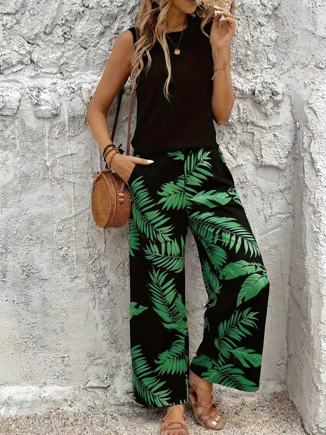 Two-piece botanical wide-leg set with sleeveless top, black with green leaf print pants