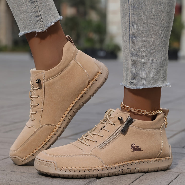 Beige lace-up comfort shoes with side zipper, stitched sole, and gold ankle chain